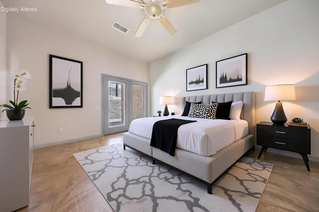 a bedroom with a bed and a chandelier