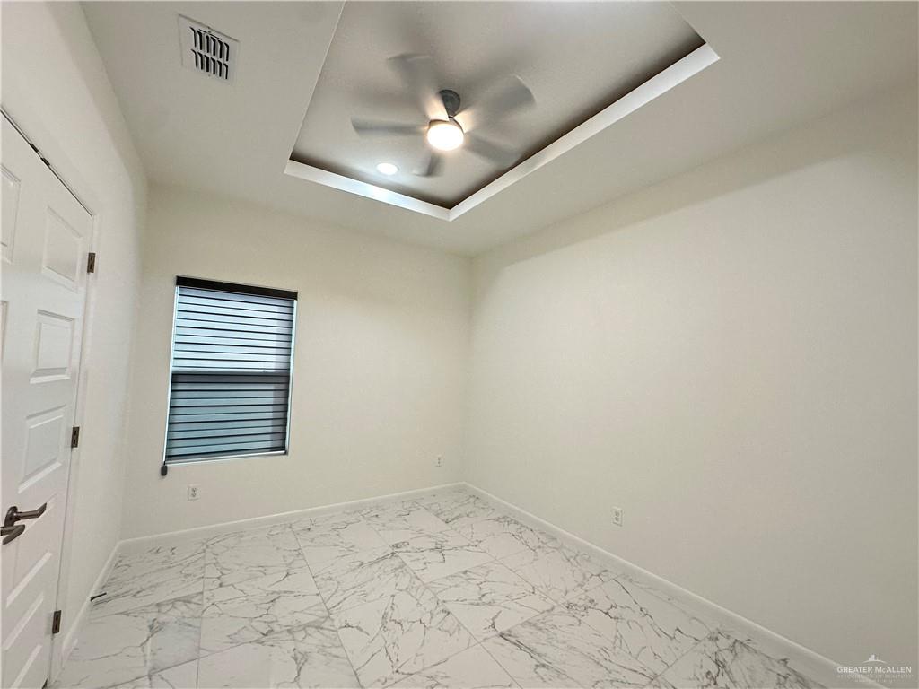 2300 East San Andrea Street, Unit 2 Edinburg, TX 78542 - Photo 11 of 12 wooden floor in an empty room with a chandelier fan
