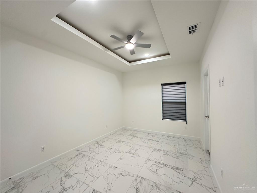2300 East San Andrea Street, Unit 2 Edinburg, TX 78542 - Photo 6 of 12 an empty room with a ceiling fan and carpet
