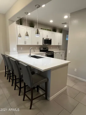 a large kitchen with a table and chairs