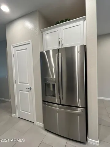 a metallic refrigerator freezer sitting in a kitchen