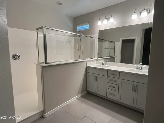 a bathroom with a double vanity sink mirror and double