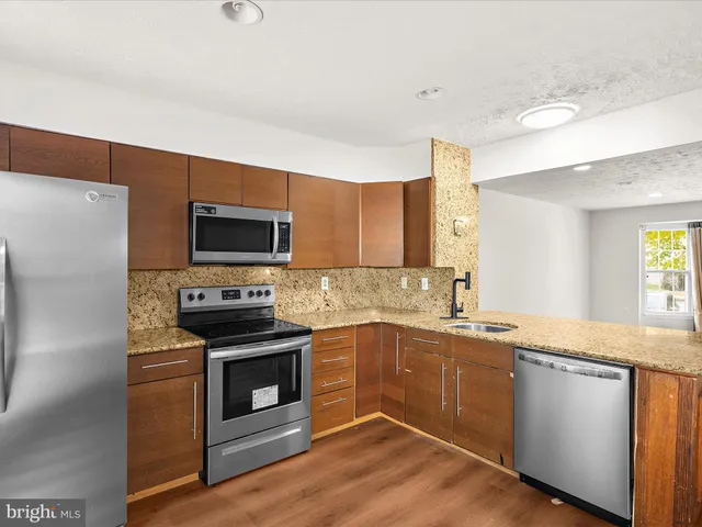 a kitchen with a sink stove and microwave