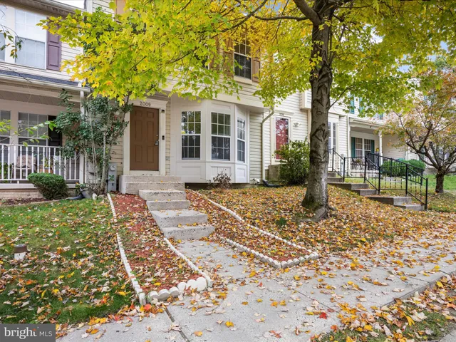 front view of a house with a tree in front
