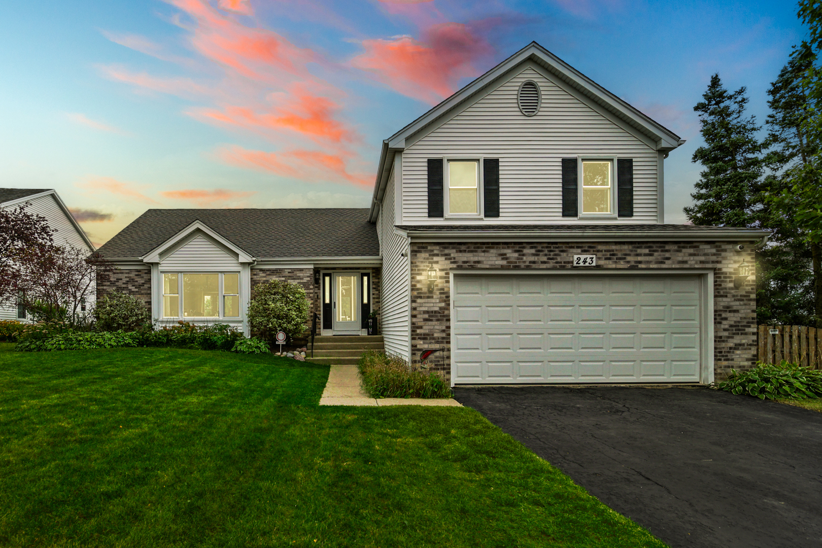 243 Yorkshire Drive Fox River Grove, IL 60021 - Photo 2 of 2 a front view of a house with a yard and garage