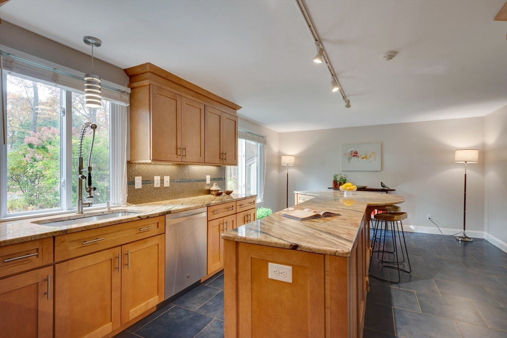 134 Chestnut Circle, Unit 134 Lincoln, MA 01773 - Photo 13 of 38 a kitchen that has a lot of cabinets a sink and appliances in it