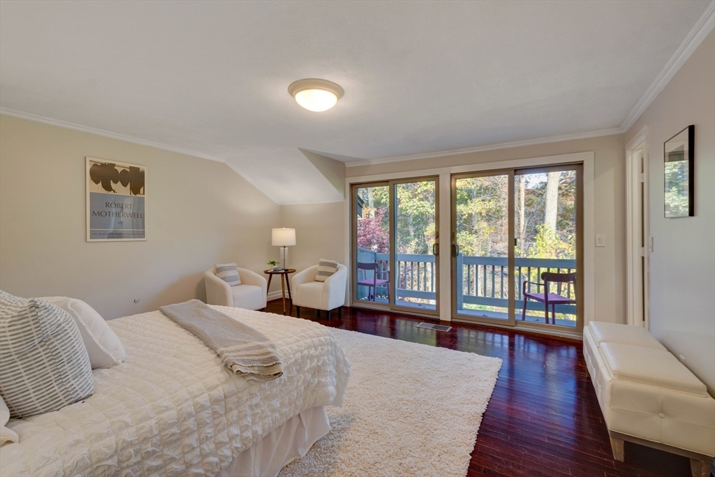 134 Chestnut Circle, Unit 134 Lincoln, MA 01773 - Photo 16 of 38 a bedroom with a large bed and a large window