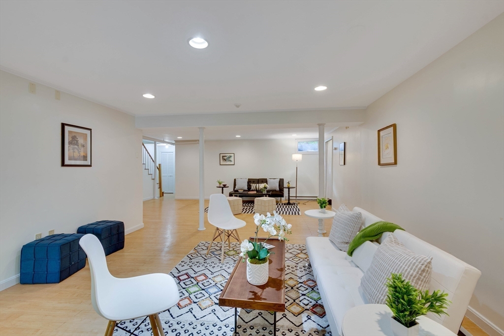 134 Chestnut Circle, Unit 134 Lincoln, MA 01773 - Photo 26 of 38 a living room with furniture potted plant and a window