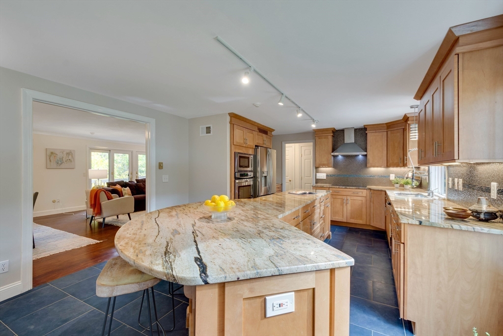 134 Chestnut Circle, Unit 134 Lincoln, MA 01773 - Photo 5 of 38 a kitchen with stainless steel appliances granite countertop sink stove and wooden cabinets