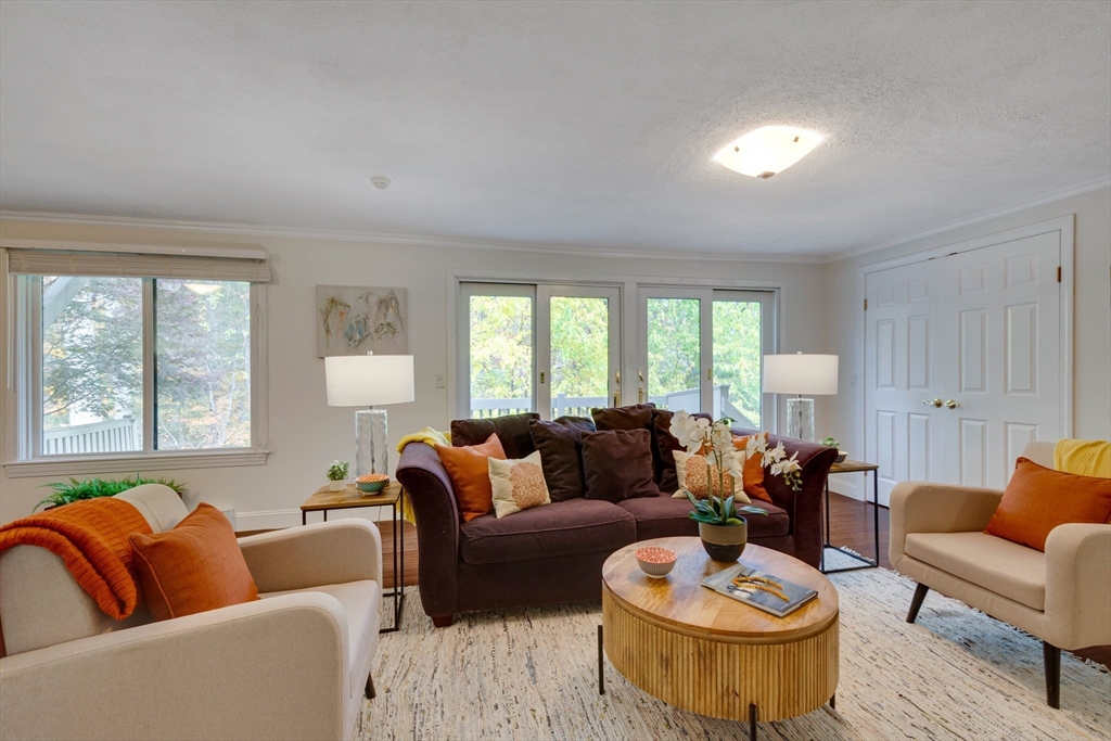 134 Chestnut Circle, Unit 134 Lincoln, MA 01773 - Photo 7 of 38 a living room with furniture and a large window