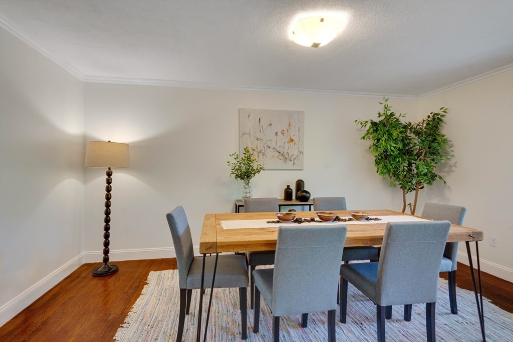 134 Chestnut Circle, Unit 134 Lincoln, MA 01773 - Photo 10 of 38 a view of a dining room with furniture and wooden floor