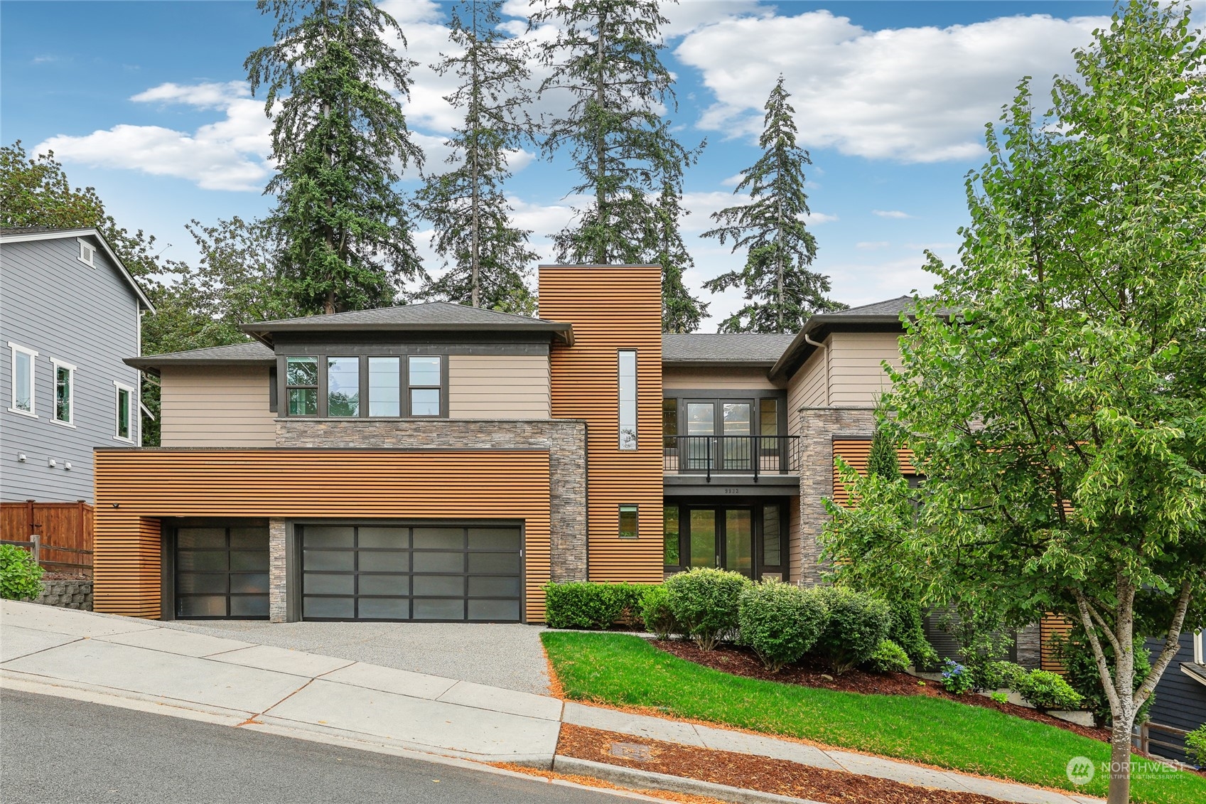 a front view of a house with a garden and plants