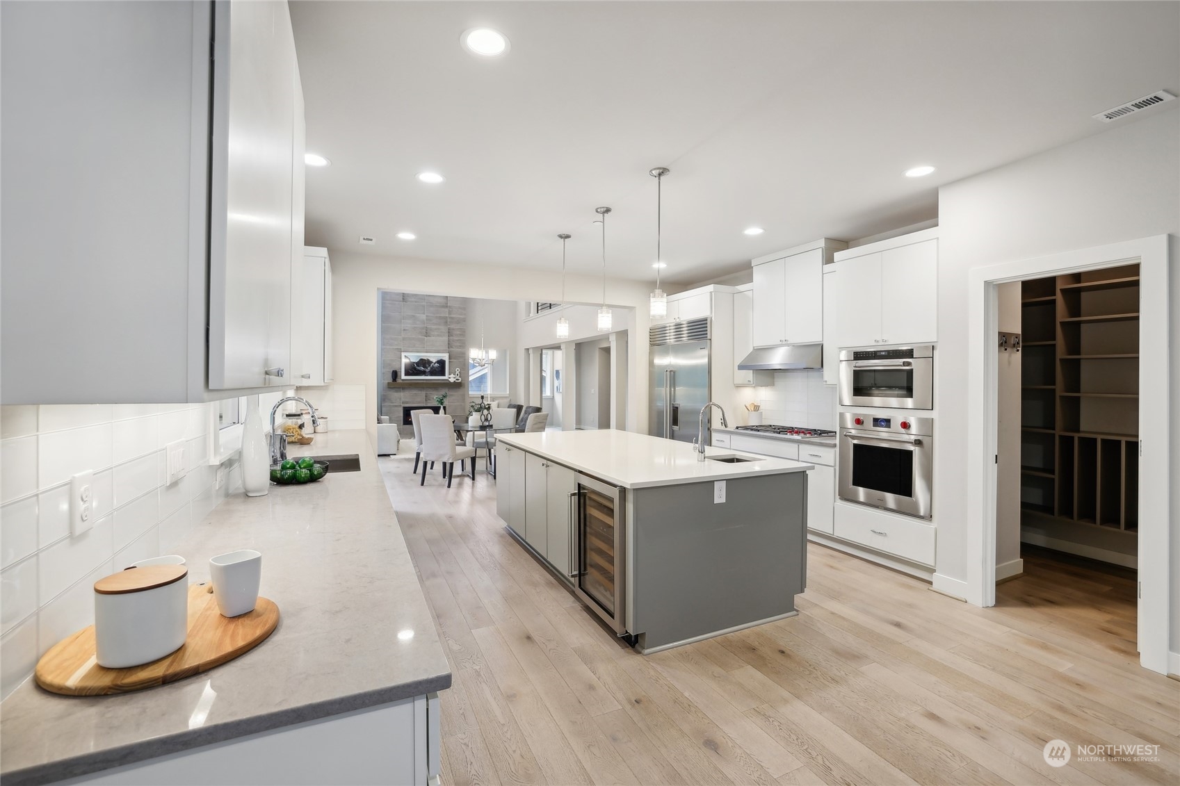 9933 Northeast 162nd Street Bothell, WA 98011 - Photo 11 of 40 a large kitchen with a large counter top stainless steel appliances and cabinets
