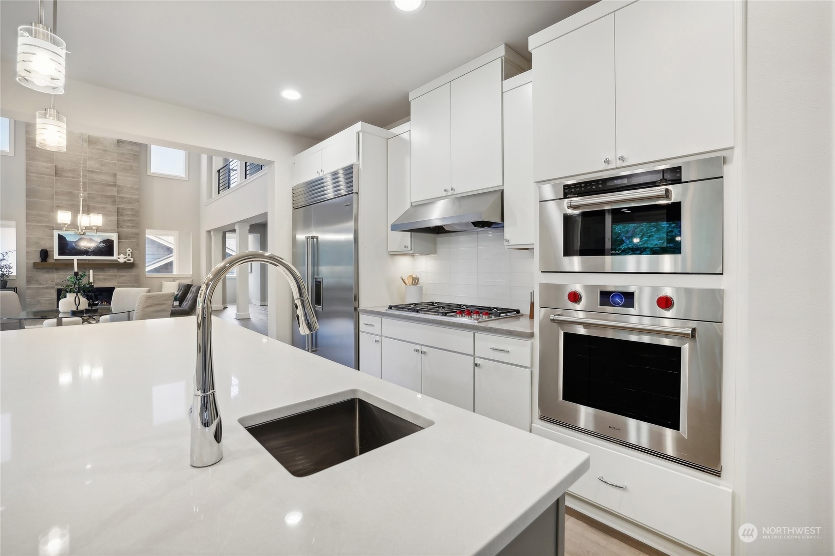 9933 Northeast 162nd Street Bothell, WA 98011 - Photo 12 of 40 a kitchen with stainless steel appliances a stove a sink and a microwave