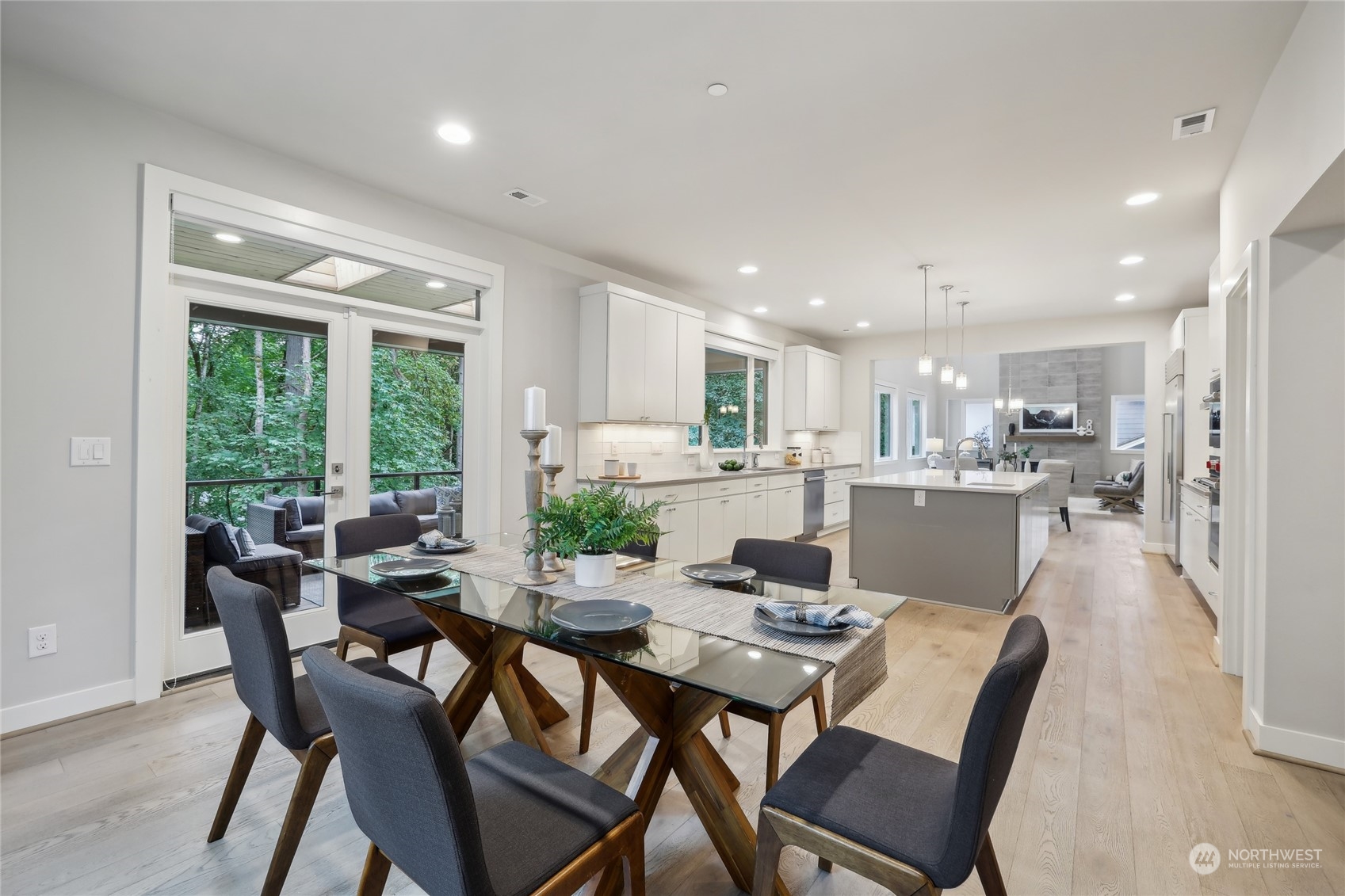 9933 Northeast 162nd Street Bothell, WA 98011 - Photo 14 of 40 a dining room with stainless steel appliances a dining table and chairs