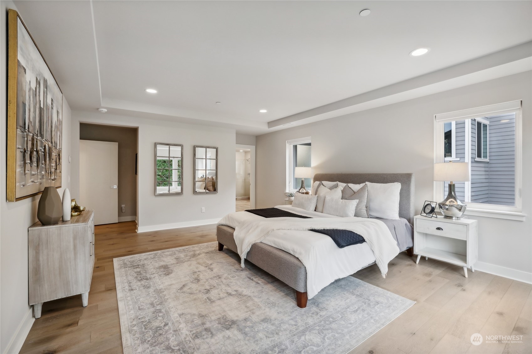 9933 Northeast 162nd Street Bothell, WA 98011 - Photo 21 of 40 a spacious bedroom with a large bed and a couch