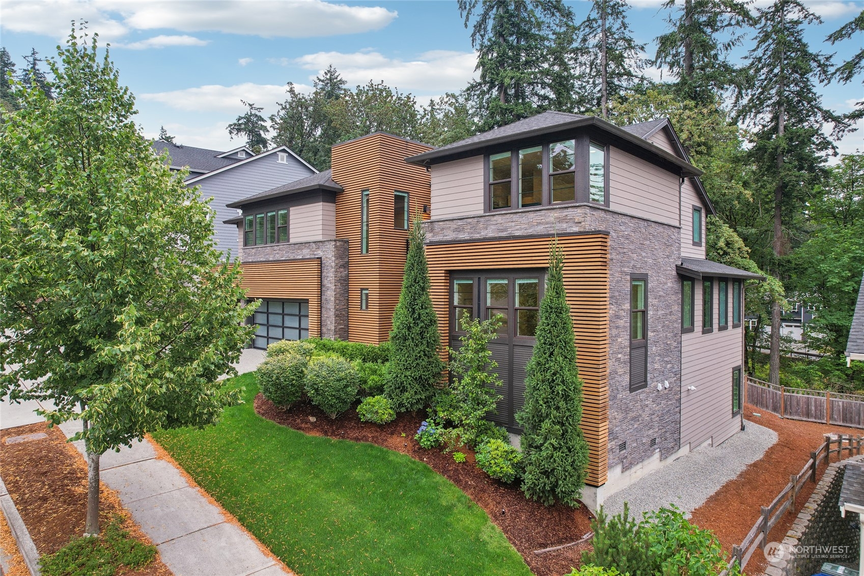 9933 Northeast 162nd Street Bothell, WA 98011 - Photo 3 of 40 a front view of a house with garden