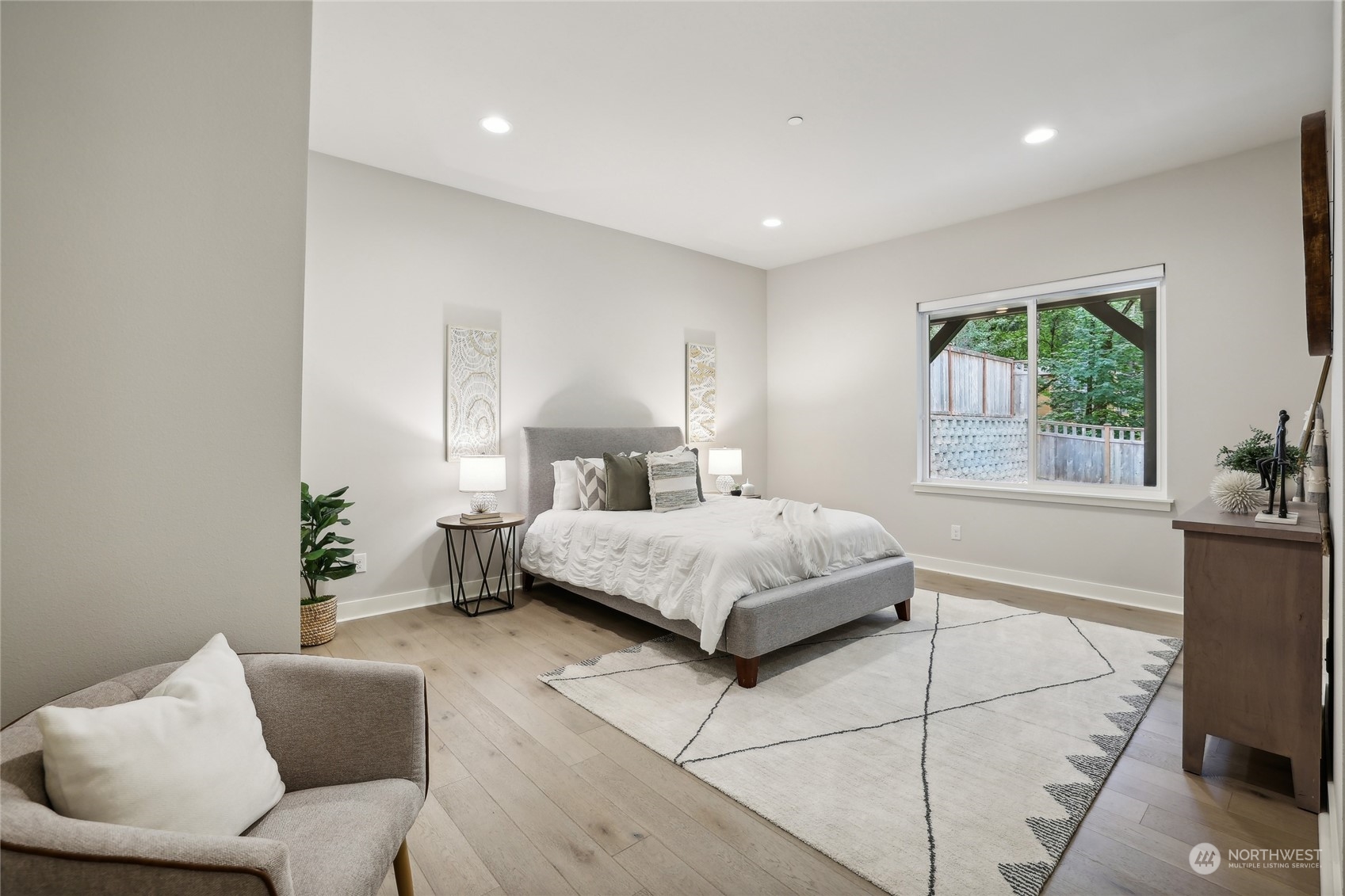 9933 Northeast 162nd Street Bothell, WA 98011 - Photo 31 of 40 a bedroom with a large bed and a couch