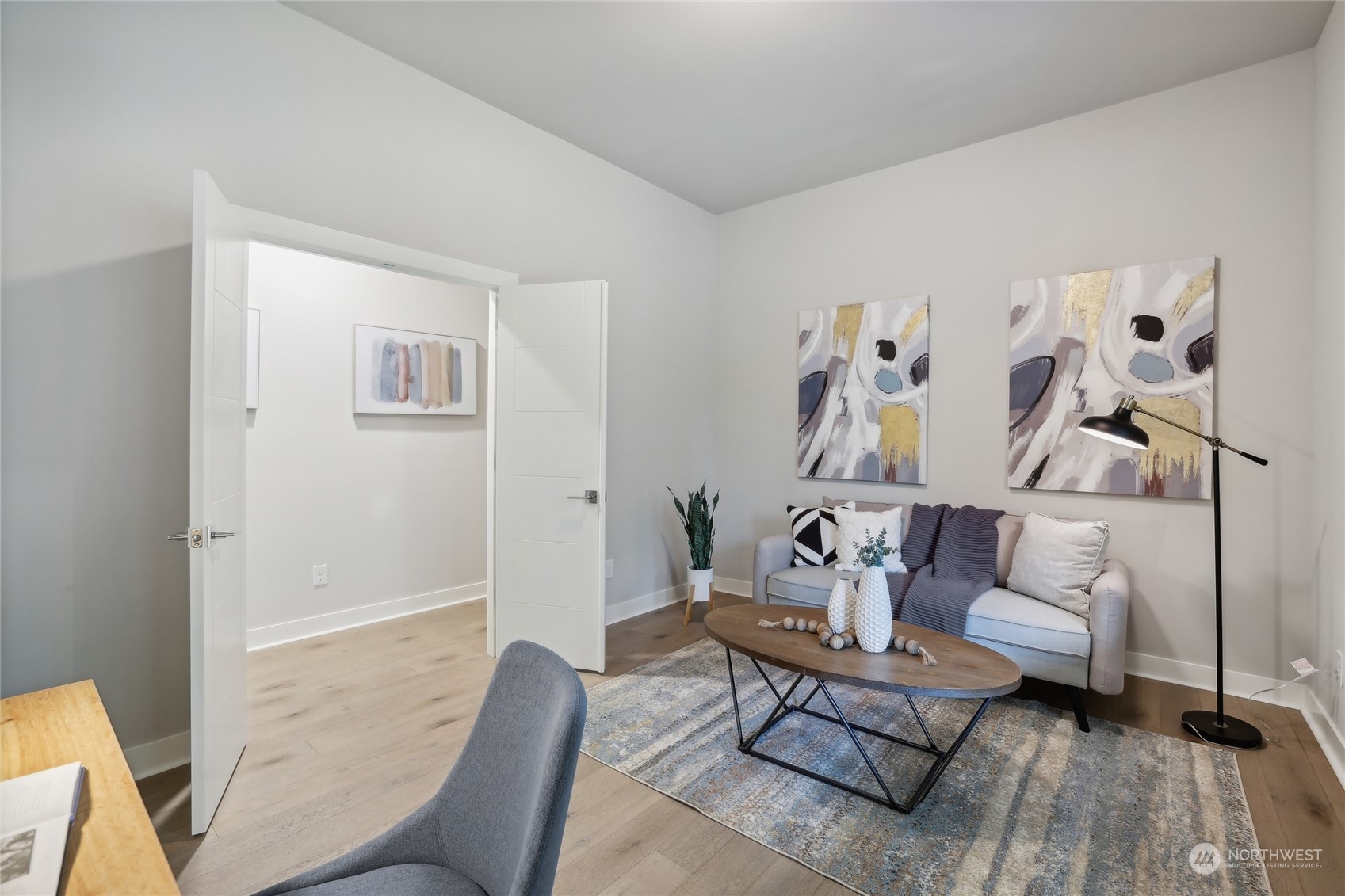 9933 Northeast 162nd Street Bothell, WA 98011 - Photo 33 of 40 a living room with furniture and wooden floor