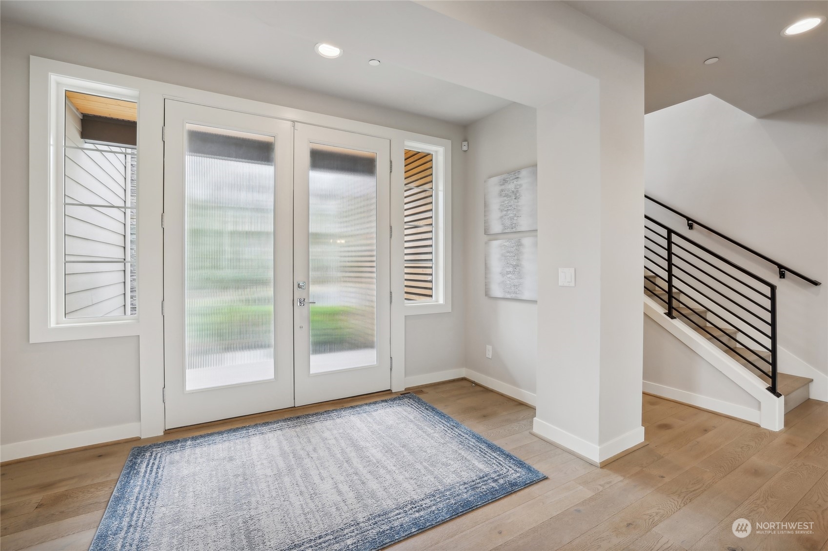 9933 Northeast 162nd Street Bothell, WA 98011 - Photo 5 of 40 an empty room with wooden floor and windows
