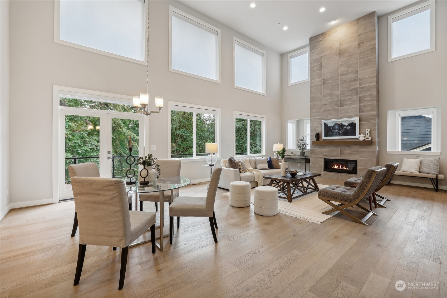 9933 Northeast 162nd Street Bothell, WA 98011 - Photo 7 of 40 a living room with furniture a fireplace and a floor to ceiling window