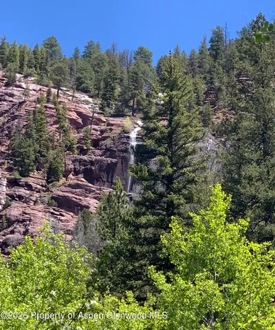 a view of a green field with lots of bushes
