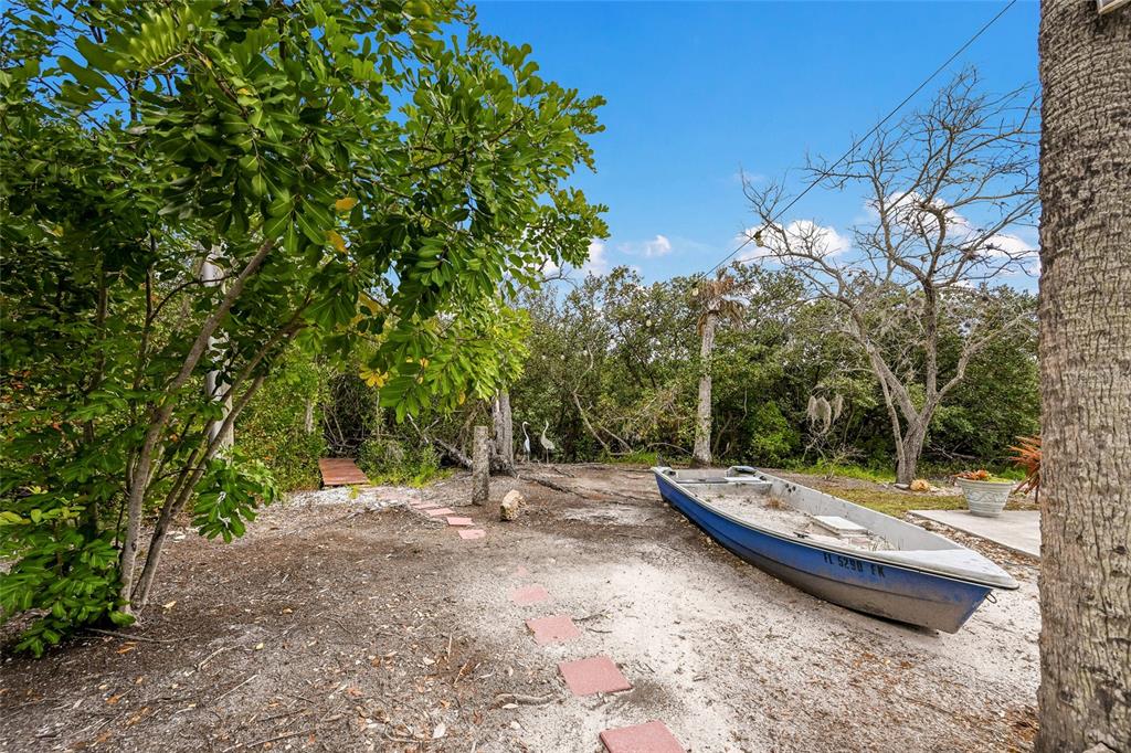 7325 Holly Road Terra Ceia, FL 34250 - Photo 68 of 87 a view of a backyard with water fountain and large trees
