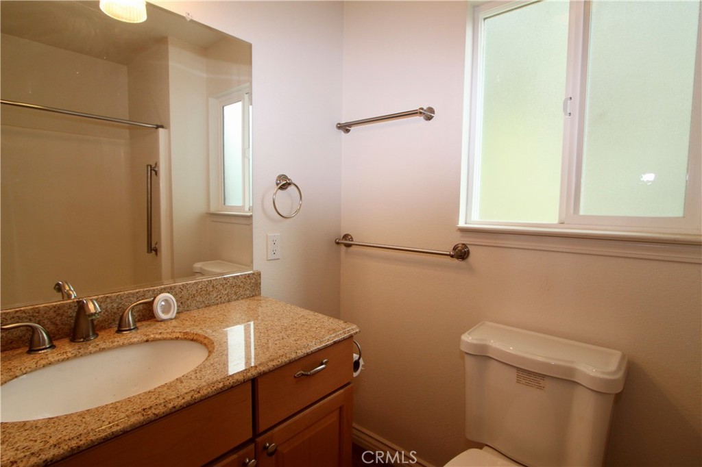 3085 Gardner Road Nice, CA 95464 - Photo 16 of 20 a bathroom with a granite countertop sink toilet and mirror