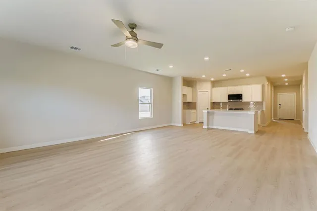 a view of a kitchen with a sink and a refrigerator