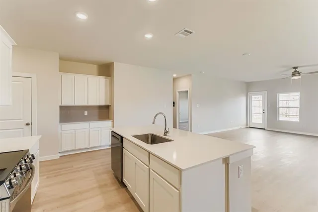 a kitchen with a sink cabinets and window