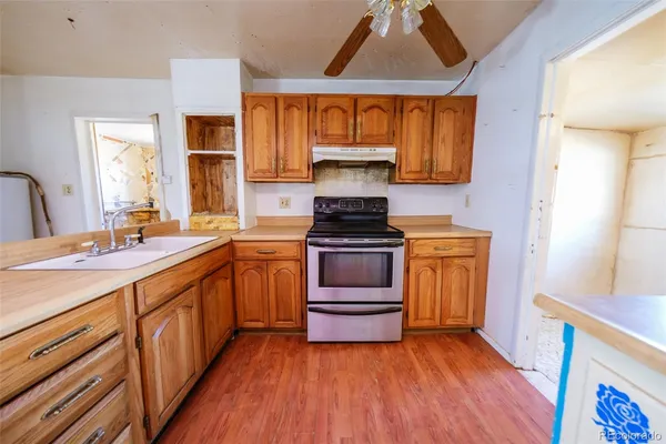 a kitchen with stainless steel appliances granite countertop a stove and a sink