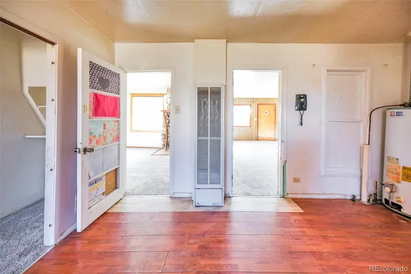 a view of an entryway with wooden floor