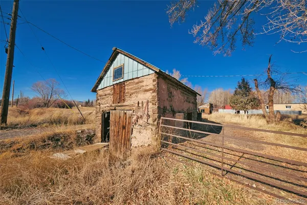a view of a backyard with a wooden fence