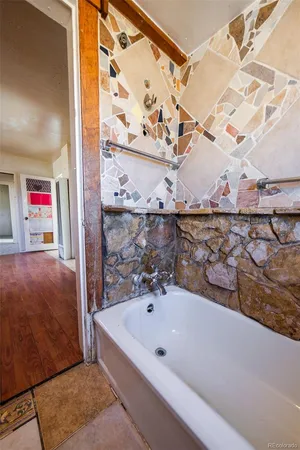 a bathroom with a bathtub and shower