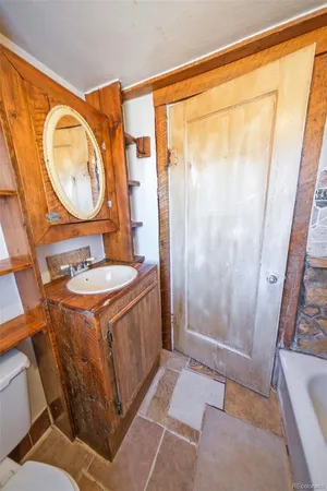 a bathroom with a sink a mirror and a shower