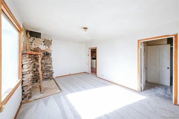a view of a room with wooden floor