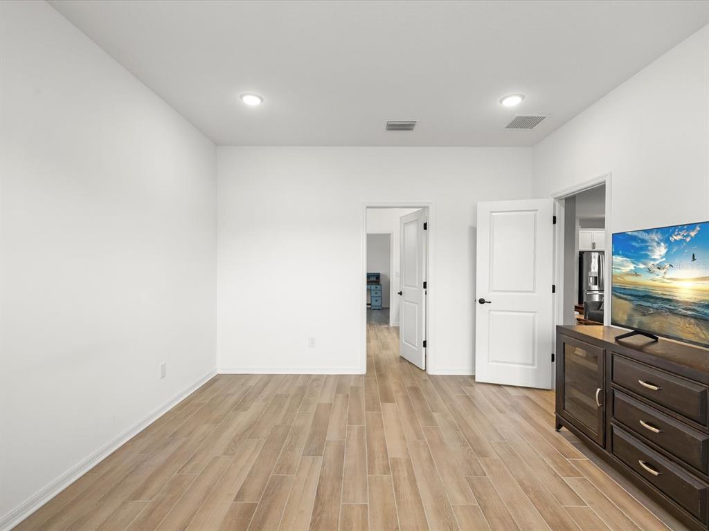 5219 Cappleman Loop Brooksville, FL 34601 - Photo 22 of 60 a view of room with wooden floor and flat screen tv
