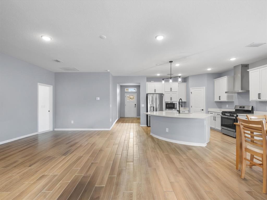 5219 Cappleman Loop Brooksville, FL 34601 - Photo 30 of 60 a view of kitchen with cabinets and wooden floor