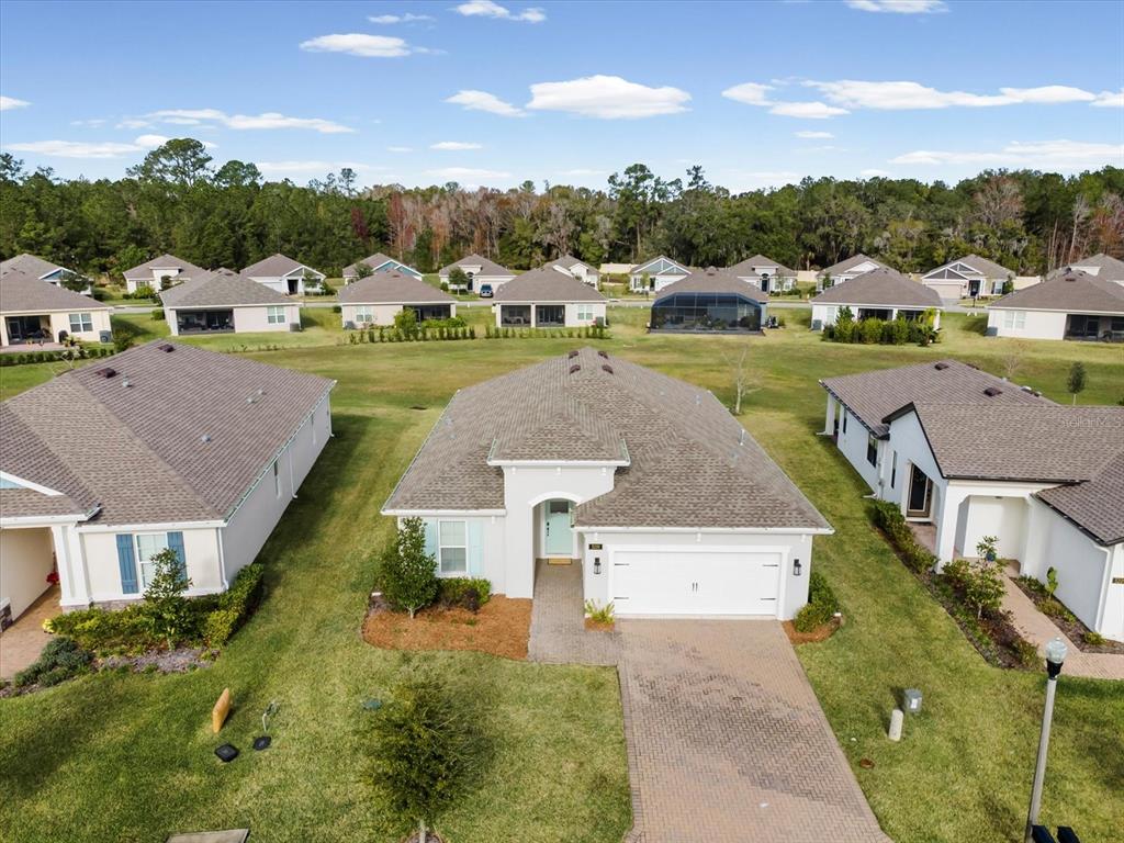 5219 Cappleman Loop Brooksville, FL 34601 - Photo 38 of 60 an aerial view of a house with a garden and houses