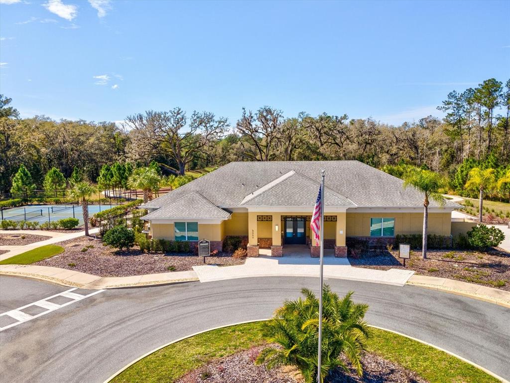 5219 Cappleman Loop Brooksville, FL 34601 - Photo 43 of 60 a patio with a table and chairs under an umbrella