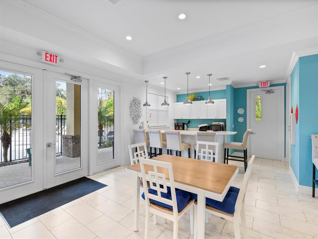 5219 Cappleman Loop Brooksville, FL 34601 - Photo 45 of 60 a open dining room with stainless steel appliances kitchen island granite countertop a refrigerator a stove a microwave oven with white cabinets and island