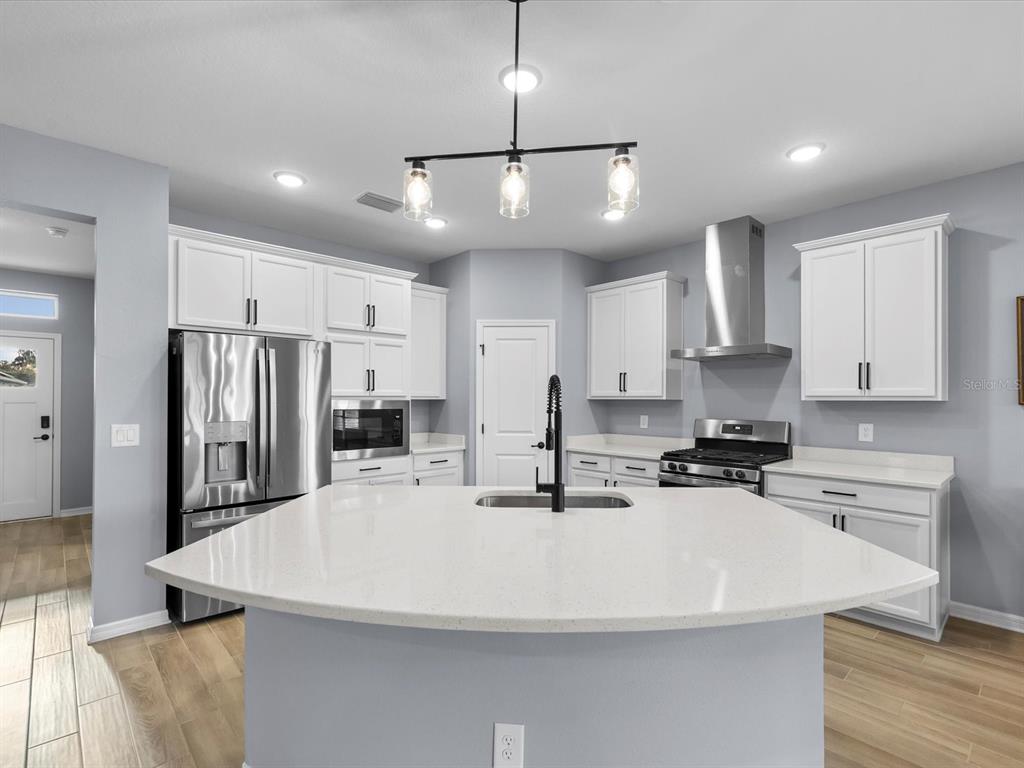 5219 Cappleman Loop Brooksville, FL 34601 - Photo 6 of 60 a kitchen with stainless steel appliances a refrigerator sink and microwave