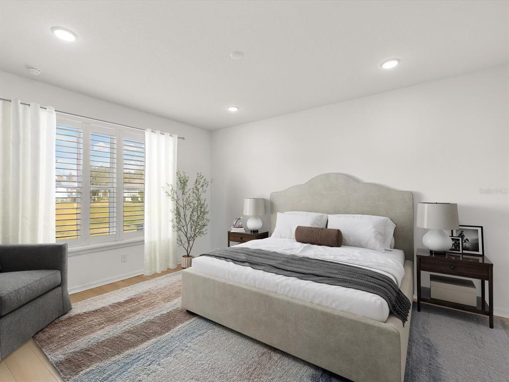 5219 Cappleman Loop Brooksville, FL 34601 - Photo 8 of 60 a bedroom with a bed and a couch