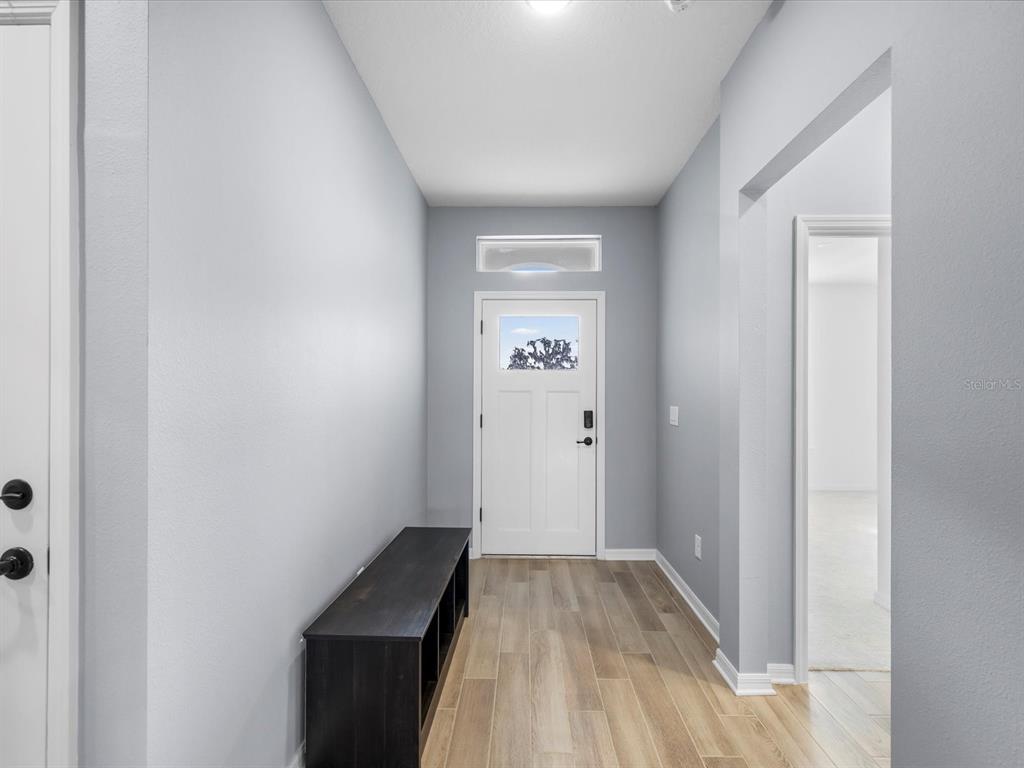 5219 Cappleman Loop Brooksville, FL 34601 - Photo 9 of 60 a view of a room with wooden floor and staircase