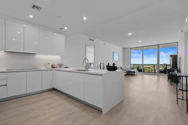 a kitchen with sink cabinets and wooden floor