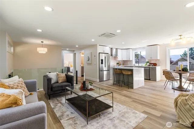 a living room with furniture and kitchen view