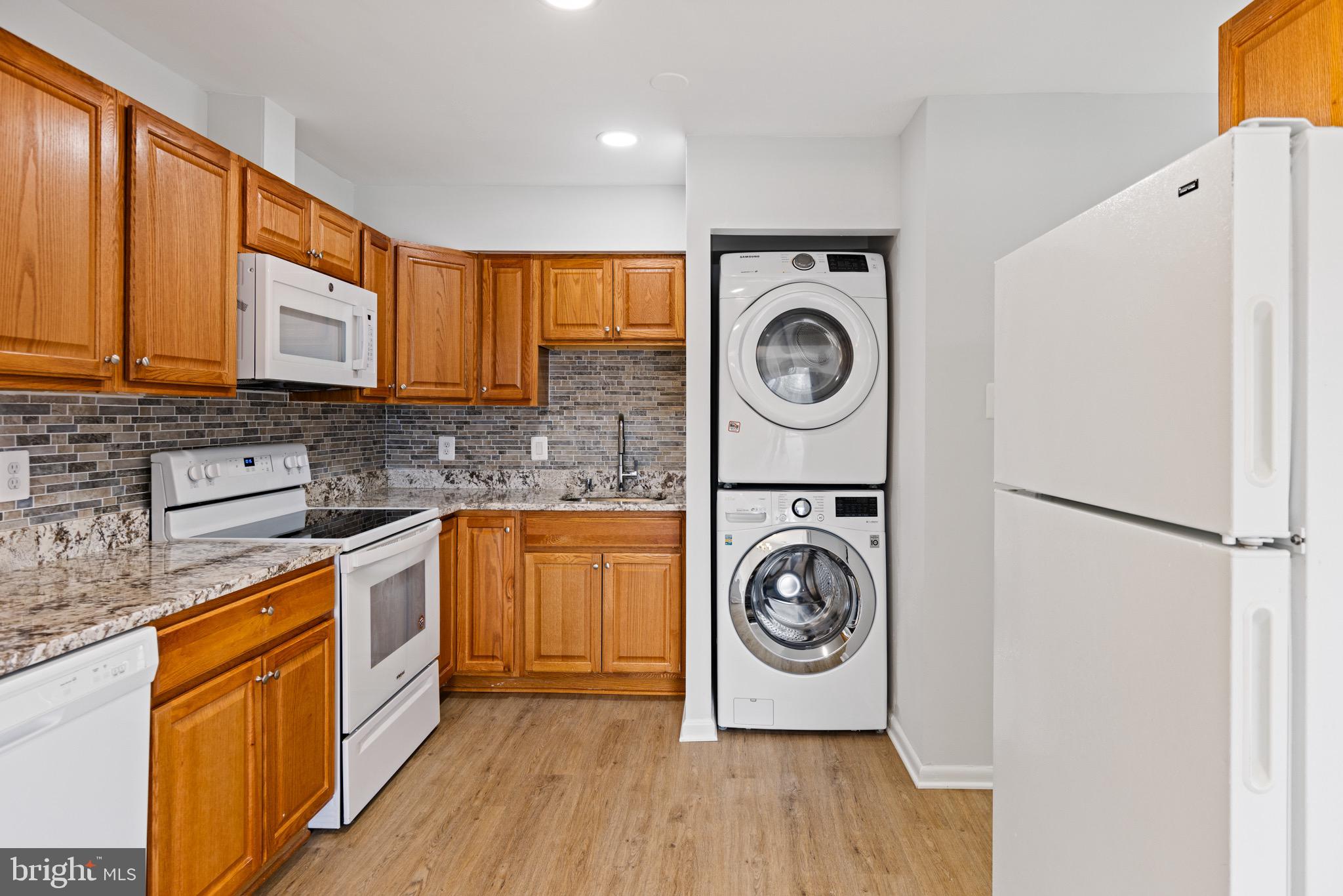 11474 Laurelwalk Drive Laurel, MD 20708 - Photo 12 of 22 a kitchen with stainless steel appliances granite countertop a stove a sink and a refrigerator