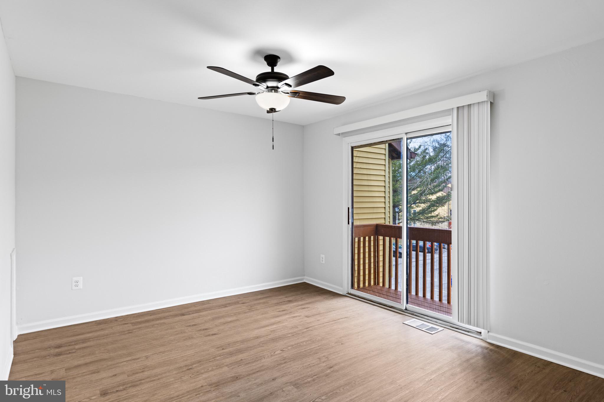 11474 Laurelwalk Drive Laurel, MD 20708 - Photo 16 of 22 an empty room with wooden floor fan and windows