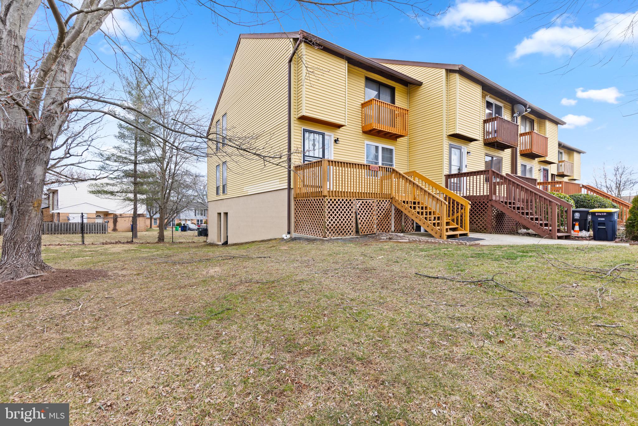 11474 Laurelwalk Drive Laurel, MD 20708 - Photo 2 of 22 a view of a large white house with a yard