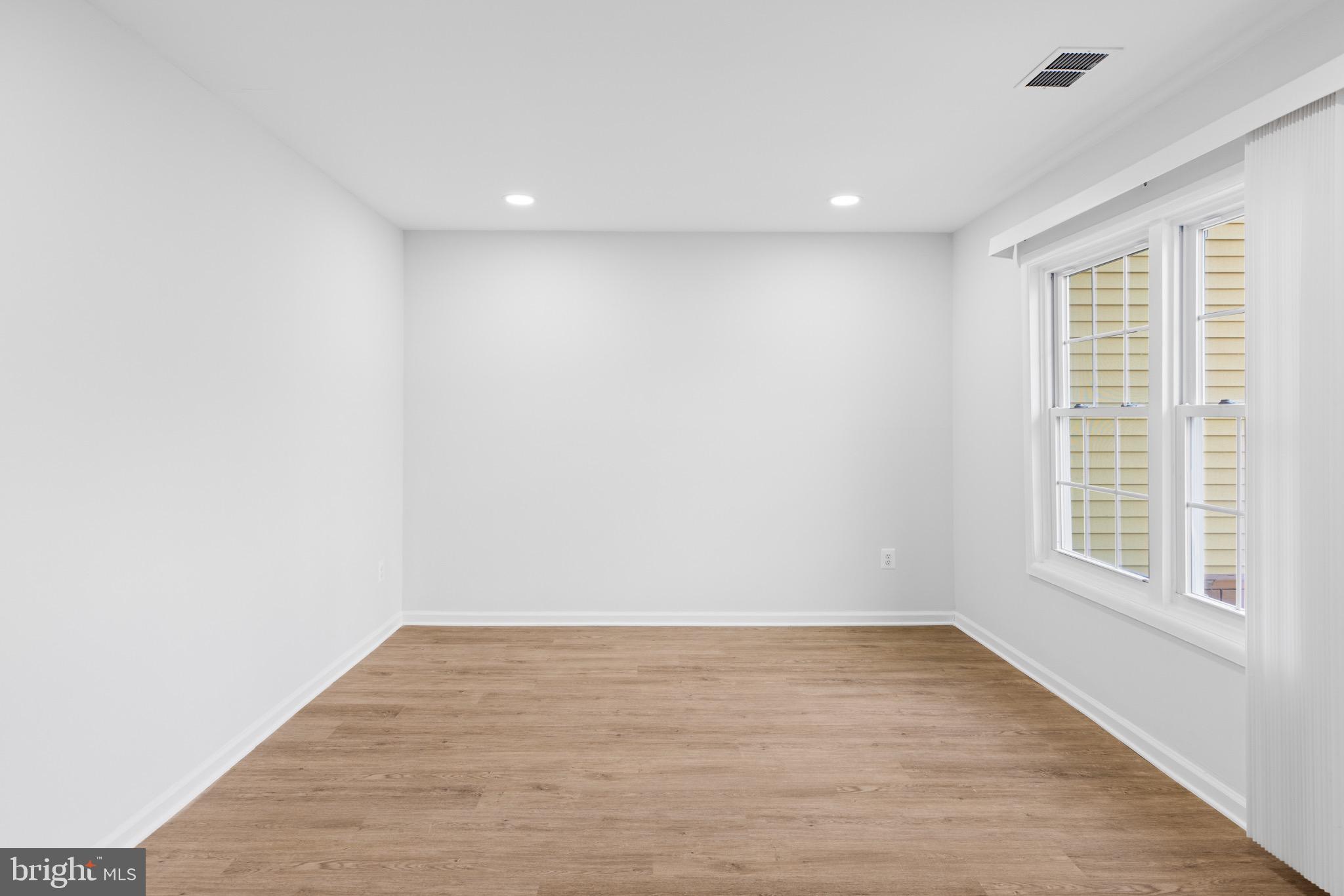 11474 Laurelwalk Drive Laurel, MD 20708 - Photo 6 of 22 a view of empty room with wooden floor and fan
